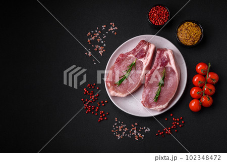 Raw pork on the bone or rib sliced with salt, spices and herbs 102348472