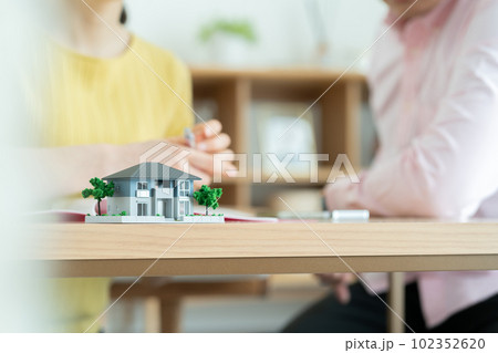 マイホーム計画を立てる夫婦　住まいの検討をするカップル 102352620