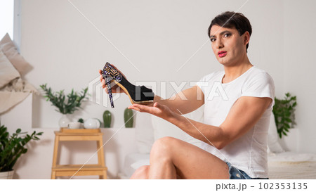 Gay trying on high heels. The guy with makeup. 102353135