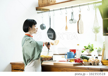 カボチャのパンケーキを作る若い女性 カボチャのパンケーキを作る若い女性 102353519