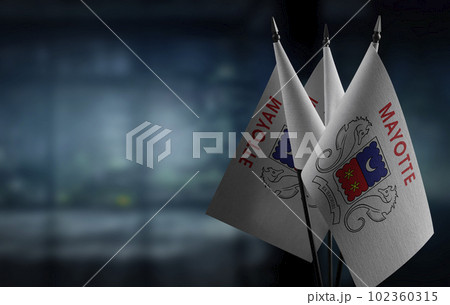 Small flags of the Mayotte on an abstract blurry background Small flags of the Mayotte on an abstract blurry background 102360315