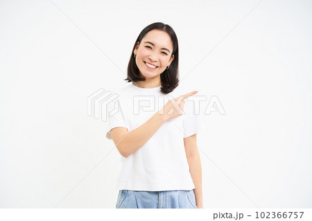 Beautiful young smiling woman, pointing right, showing banner, advertisement on blank empty copy space, isolated on white background Beautiful young smiling woman, pointing right, showing banner, advertisement on blank empty copy space, isolated on white background 102366757