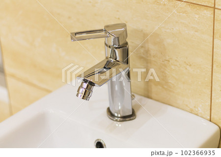 Stainless steel faucet of bidet in bathroom close-up Stainless steel faucet of bidet in bathroom close-up 102366935