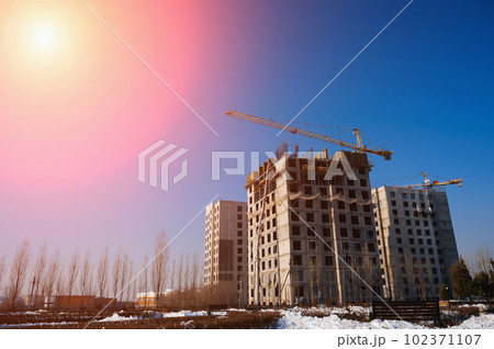 construction crane is building a residential building on a construction site 102371107