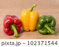 Ripe vibrant colorful peppers on sackcloth Ripe vibrant colorful peppers on sackcloth 102371544
