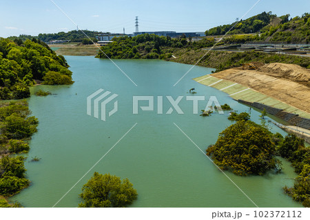 ダム建設で水没する川沿いの道路と道路標識 102372112