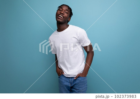 a dark-skinned European young man with dreadlocks is dressed in a white T-shirt for printing 102373983
