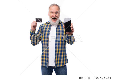 handsome elderly gray-haired retired man with mustache and beard with card and phone mockup 102373984