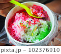 Shave ice with red and green syrup. 102376910