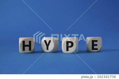 Hype symbol. Concept word Hype on wooden cubes. Beautiful blue background. Business and Hype concept. Copy space. 102381736