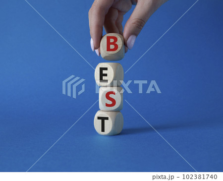 Best symbol. Concept word Best on wooden cubes. Businessman hand. Beautiful blue background. Business and Best concept. Copy space. 102381740