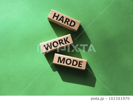 Hard Work Mode symbol. Concept word Hard Work Mode on wooden blocks. Beautiful green background. Business and Hard Work Mode concept. Copy space 102381970