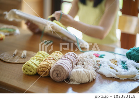 Punch needle. Asian Woman making handmade Hobby knitting in studio workshop. designer workplace Handmade craft project DIY embroidery concept. Punch needle. Asian Woman making handmade Hobby knitting in studio workshop. designer workplace Handmade craft project DIY embroidery concept. 102383119