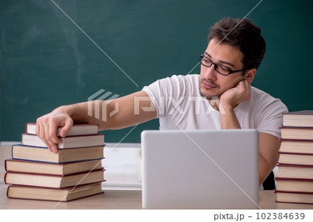 Young male student sitting in the classroom Young male student sitting in the classroom 102384639