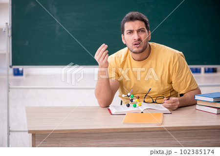 Young male student physicist sitting in the classroom 102385174
