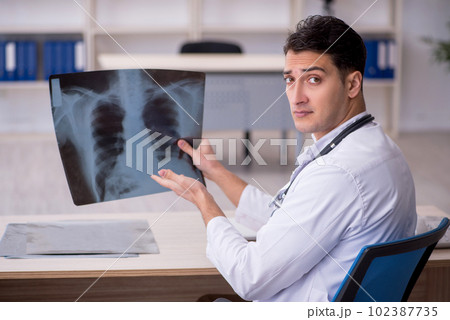 Young male doctor radiologist sitting in the clinic Young male doctor radiologist sitting in the clinic 102387735