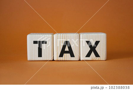 Tax symbol. Wooden cubes with word Tax. Beautiful orange background. Business and Finace and Tax concept. Copy space. Tax symbol. Wooden cubes with word Tax. Beautiful orange background. Business and Finace and Tax concept. Copy space. 102388038