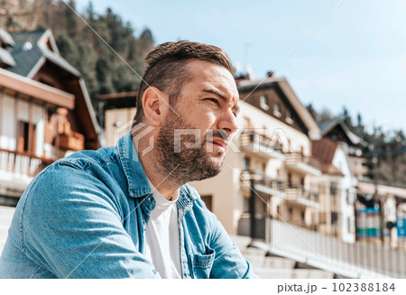 Portrait of a handsome hipster man in a jean jacket. A man in a big city on the street, a life style concept Portrait of a handsome hipster man in a jean jacket. A man in a big city on the street, a life style concept 102388184