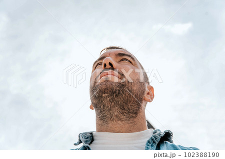 Portrait of a handsome hipster man in a jean jacket. A man in a big city on the street, a life style concept 102388190