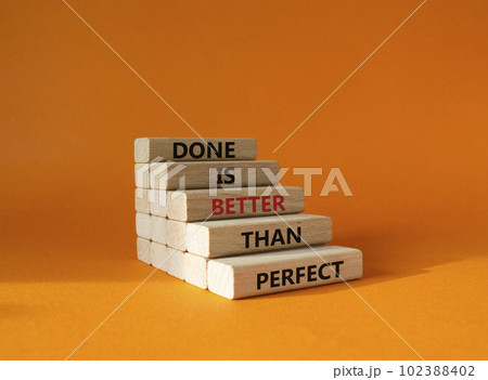 Done is better than Perfect symbol. Wooden blocks with words Done is better than Perfect. Beautiful orange background. Business and Done is better than Perfect concept. Copy space. 102388402