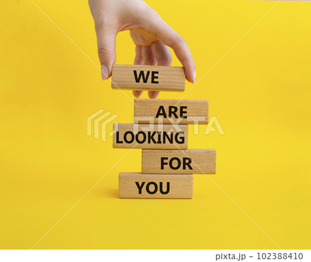 Tell us what you think symbol. Wooden blocks with words Tell us what you think. Beautiful yellow background. Businessman hand. Business and Tell us what you think concept. Copy space. 102388410