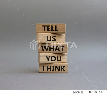 Tell us what you think symbol. Wooden blocks with words Tell us what you think. Beautiful grey background. Business and Tell us what you think concept. Copy space. 102388417