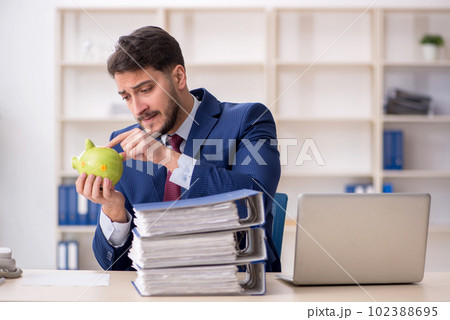 Young male employee in planning retirement concept 102388695