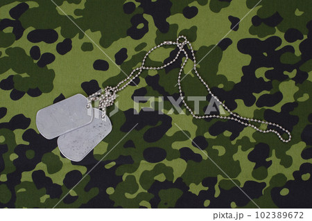 dog tags on camouflage uniform dog tags on camouflage uniform 102389672