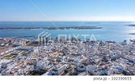 Aerial view of Portuguese fishing tourist town of Olhao overlooking Ria Formosa Marine Park. church Matriz de Nossa Senhora do Rosario Aerial view of Portuguese fishing tourist town of Olhao overlooking Ria Formosa Marine Park. church Matriz de Nossa Senhora do Rosario 102390655
