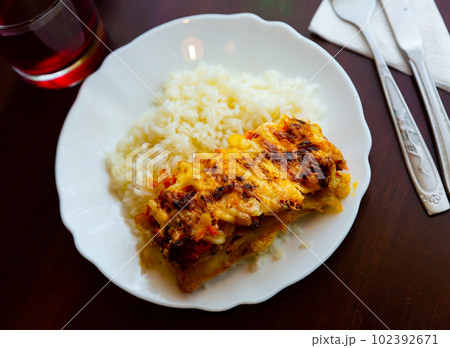 Baked chicken fillet with mushrooms and rice. Russian cuisine Baked chicken fillet with mushrooms and rice. Russian cuisine 102392671