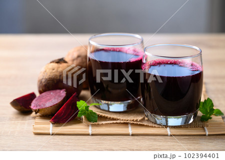 Fresh beetroot juice in glass on wooden table, Healthy drink 102394401