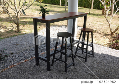 Black wooden table and chairs in the park, furniture in the garden Black wooden table and chairs in the park, furniture in the garden 102394982