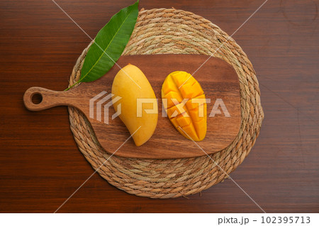Ripe mango on wood,Ripe Mango Slice on wooden cutting board 102395713