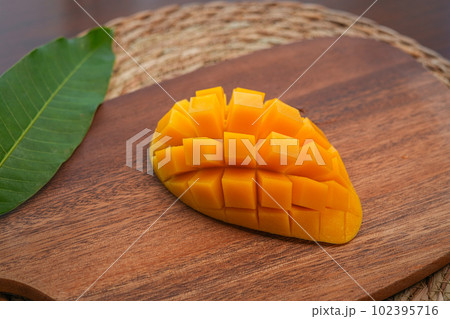 Ripe mango on wood,Ripe Mango Slice on wooden cutting board 102395716