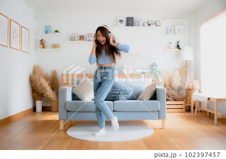 Young asian woman dancing in living room 102397457
