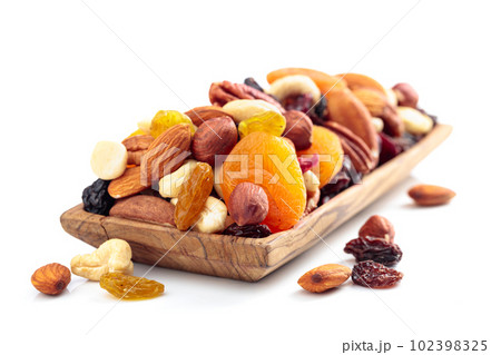 Mix of nuts and dried fruits isolated on a white background. 102398325
