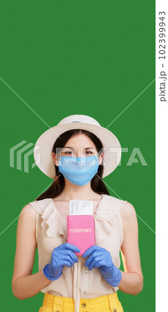 Pandemic travel. Summer vacation. Satisfied woman in medical mask gloves holding passport tickets documents traveling abroad isolated green copy space background. 102399943