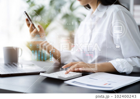Business woman hand Project manager working and update tasks and Gantt chart scheduling virtual diagram.with smart phone, tablet and laptop in office. 102400243