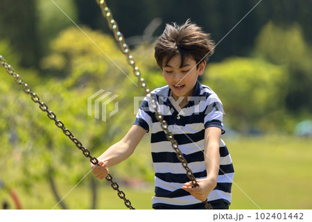 A young boy on a swing 102401442