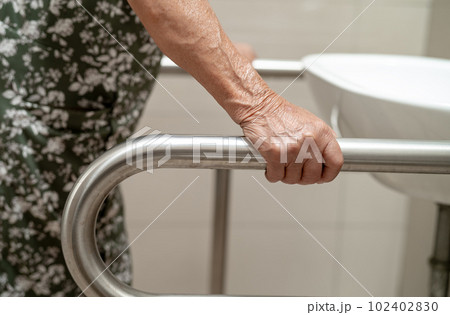 Asian elderly old lady woman patient use toilet bathroom handle security in nursing hospital, healthy strong medical concept. Asian elderly old lady woman patient use toilet bathroom handle security in nursing hospital, healthy strong medical concept. 102402830