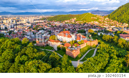 Brasov, Romania - Beautiful sunset light over the medieval Citadel. Brasov, Romania - Beautiful sunset light over the medieval Citadel. 102403154