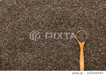 Space for text Texture of chia seeds with wooden spoon, superfood concept. Top view 102404047