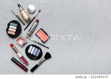 Professional makeup tools. Top view. Flat lay. Beauty, decorative cosmetics. Makeup brushes set and color eyeshadow palette on table background. Minimalistic style 102404135
