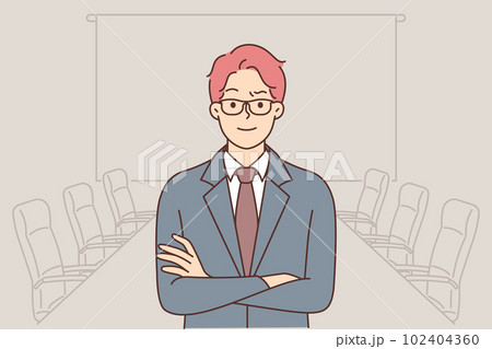 Confident business man stands in boardroom and looks at camera with arms crossed 102404360