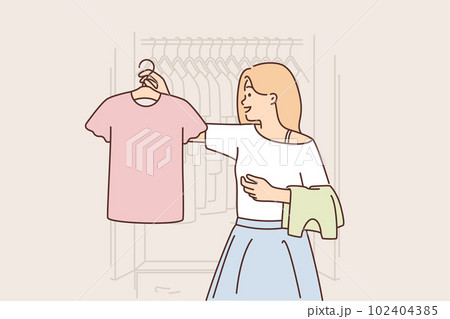 Woman chooses clothes from wardrobe going to party or sorting out t-shirts for thrift store Woman chooses clothes from wardrobe going to party or sorting out t-shirts for thrift store 102404385