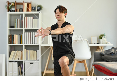 Male athlete in sportswear stretching arms muscular before workout. Healthy lifestyle and fitness concept 102406204