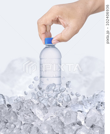 A man hand with bottle of water passing through ice cubes 102406936