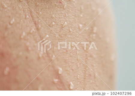 Female body skin with water drops in shower 102407296