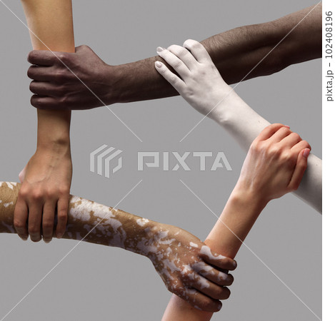 Human hands of diverse people of different race, skin tone holding each other, connected over grey background 102408196