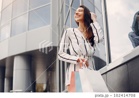 Beautiful girl in a summer city. Lady with shopping bags Beautiful girl in a summer city. Lady with shopping bags 102414708